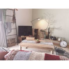 a living room filled with furniture and a flat screen tv sitting on top of a wooden table