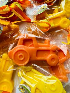 orange and yellow plastic toys are in the packaging for children's birthday party favors