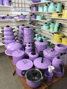 purple pots and pans are on display in a store