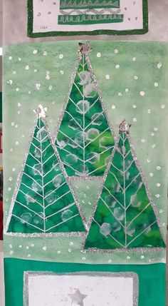 a green and white christmas card with three trees on it