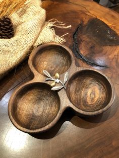 three wooden bowls sitting on top of a table