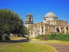 an old building with two towers and trees