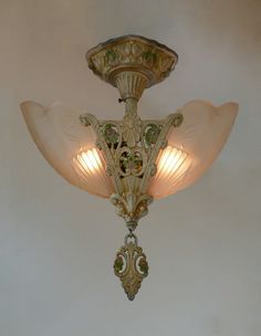 a chandelier hanging from the ceiling with two lights on it's sides