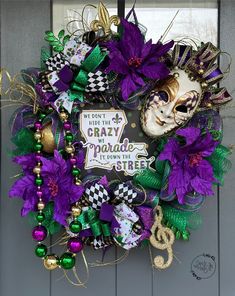 a mardi gras wreath with purple and green decorations