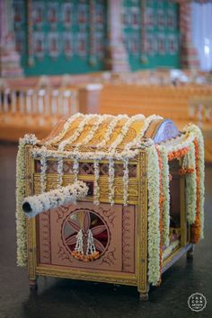 an elaborately decorated cart with flowers on it