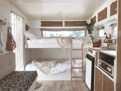 a bunk bed in a small room next to a stove