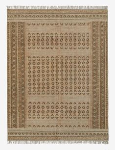 an old rug with fringes on the edges and a design in brown, beige and tan