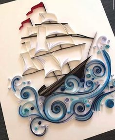 a paper cut ship floating on top of the ocean