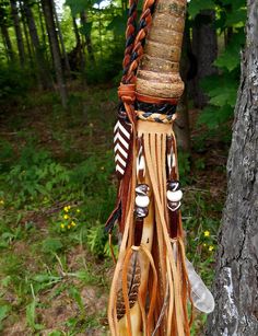 a tree that has some kind of thing hanging from it's trunk in the woods