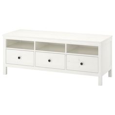 a white entertainment center with three drawers