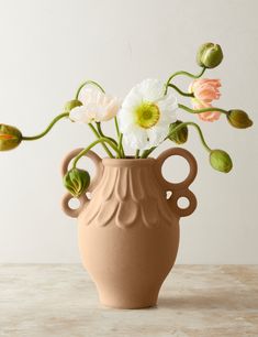 a vase with flowers in it sitting on a table