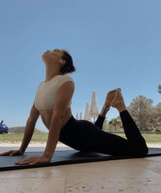 a woman is doing yoga on a mat