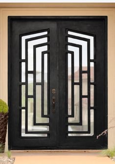 a black double door with decorative glass