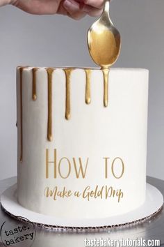 a person holding a spoon over a cake with gold drips on it and the words how to make a gold drip on top