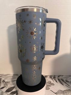 a blue coffee cup sitting on top of a table