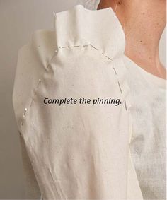 a woman wearing a white dress with the words complete the pinning on it's back