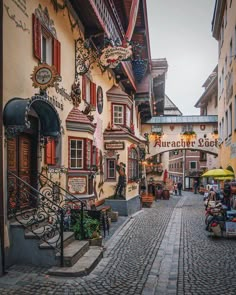 a cobblestone street lined with shops and restaurants