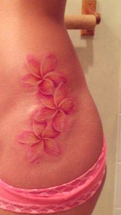 a woman's stomach with pink flowers on it