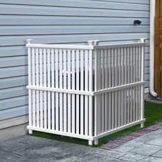 a white fence sitting in front of a house