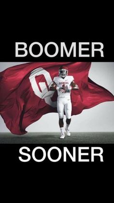 a football player holding a flag with the words boomer in front of him on it