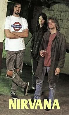 three men standing next to each other in front of a building with the words nirvana on it