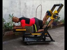 a man is doing exercises on a bench with a machine in front of his back