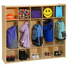 a wooden cubby filled with backpacks and shoes