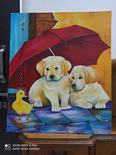 two yellow labrador retriever puppies sitting under an umbrella with a rubber ducky