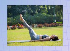 a woman is laying on her stomach in the grass and doing an upward yoga pose