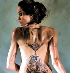 a woman with tattoos on her back