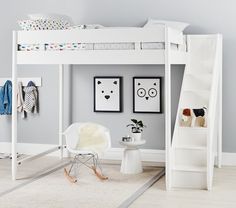 a white loft bed sitting in a bedroom next to a wall mounted art print on the wall