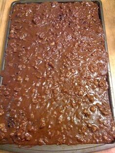 a pan filled with brownies sitting on top of a wooden table