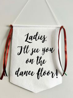 a sign hanging on the wall that says ladies, i'll see you on the dance floor