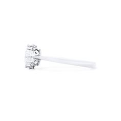 a white diamond ring with a single stone in the center on a white background,