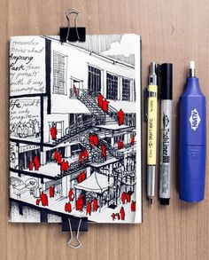 an open notebook with drawings and pens on it