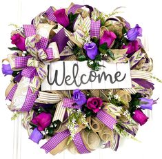 a welcome wreath with purple and white flowers