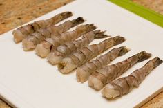 several skewers of food sitting on top of a cutting board