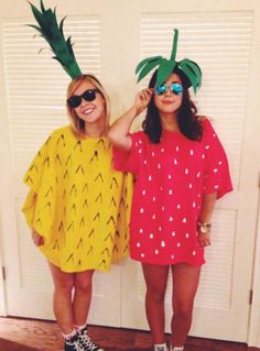 two girls wearing pineapple costumes standing next to each other in front of a door