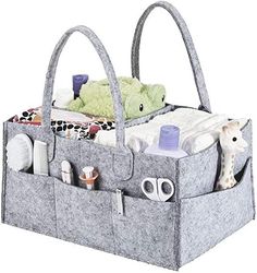 a gray bag with two stuffed animals in it and other items on the bottom shelf