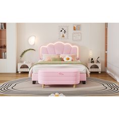 a bedroom with a pink bed and rugs on the floor in front of it