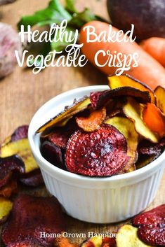 healthy baked vegetable crispes in a bowl with carrots and beets around them