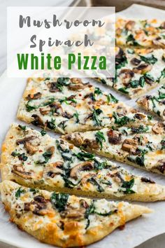 mushroom spinach white pizza cut into four slices on a baking sheet with text overlay