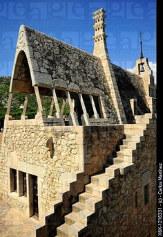 an old building with stone steps leading up to it's roof and steeple