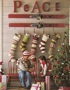 christmas stockings hanging on the wall with skis and snowboards