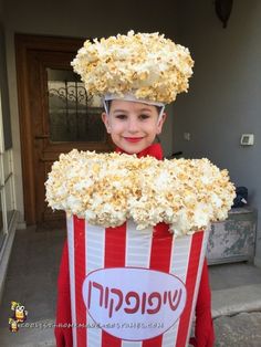 a young boy in a popcorn bucket costume