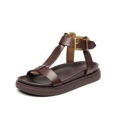 The Sara T-strap leather sandals for women from USS Shoes are made with genuine cow leather and lined with soft sheepskin, these sandals provide superior quality. Featuring a back strap and an open side vamp, these sandals have a secure fit with a buckle strap closure. Available in black and brown, perfect for casual o Brown T-strap Sandals With Tang Buckle And Round Toe, Brown T-strap Sandals With Round Toe And Tang Buckle, Spring T-strap Sandals With Tang Buckle, Leather T-strap Slingback Sandals, Leather T-strap Sandals With Round Toe And Tang Buckle, Brown T-strap Sandals With Leather Sole, Leather T-strap Sandals, Summer T-strap Sandals With Tang Buckle, Brown Leather Footbed T-strap Sandals