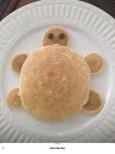 a white plate topped with pancakes shaped like a turtle