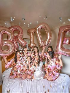 the bridesmaids are posing with giant balloons in front of their heads and body