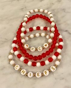 "Show your team spirit with these stretch beaded bracelets.  Red and white beads with gold detail beads and \"KC\" and \"Chiefs\" included! Bracelet length can be customized in half inch increments.  In the event the size cannot be met exactly due to the pattern, bracelet will be made slightly larger to ensure fit." Chiefs Bracelet Ideas, Football Bracelet, Bracelets Handmade Diy, Kansas City Chiefs, White Beads, Gold Details, Beaded Jewelry Diy, Bracelet Stack, Diy Bracelets