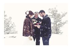 a man and woman standing next to each other in the snow